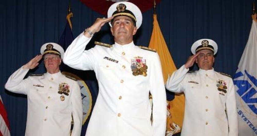 Rear Adm. Mark F. Heinrich, center, salutes at change of command ceremony. To his rear are Chief of Naval Operations Adm. Gary Roughead, left, and Rear Adm. Mike Lyden, who preceded Heinrich in the post. Photo: U.S. Navy