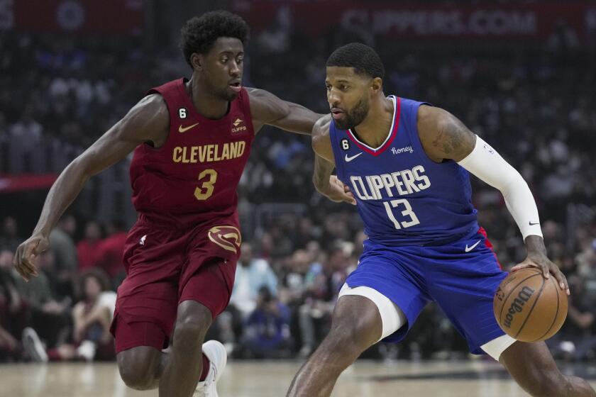 Los Angeles Clippers guard Paul George (13) controls the ball against Cleveland Cavaliers guard Caris LeVert.