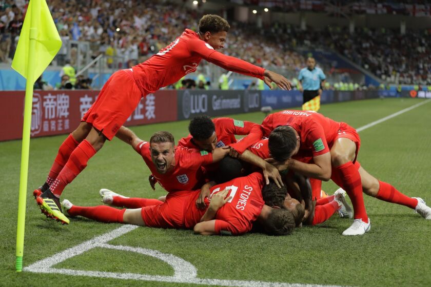 England's team celebrates after scoring the opening goal against Tunisia during the Group G match in the Volgograd Arena in Volgograd, Russia, Monday, June 18, 2018.