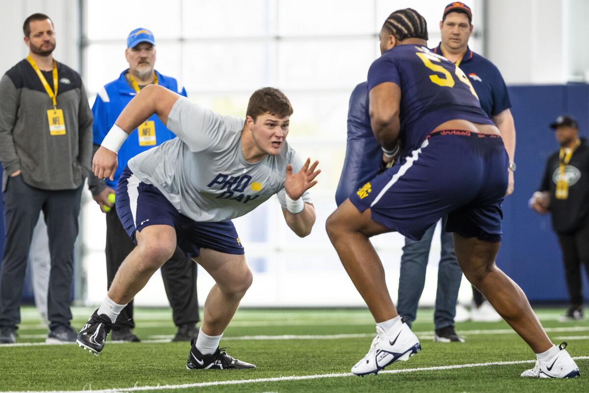 Notre Dame offensive tackle Joe Alt, left, runs a drill against offensive tackle Blake Fisher at the NFL combine.