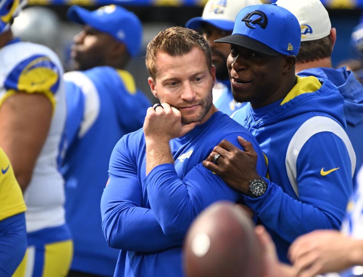 Rams head coach Sean McVay listens to defensive coordinator Raheem Morris.