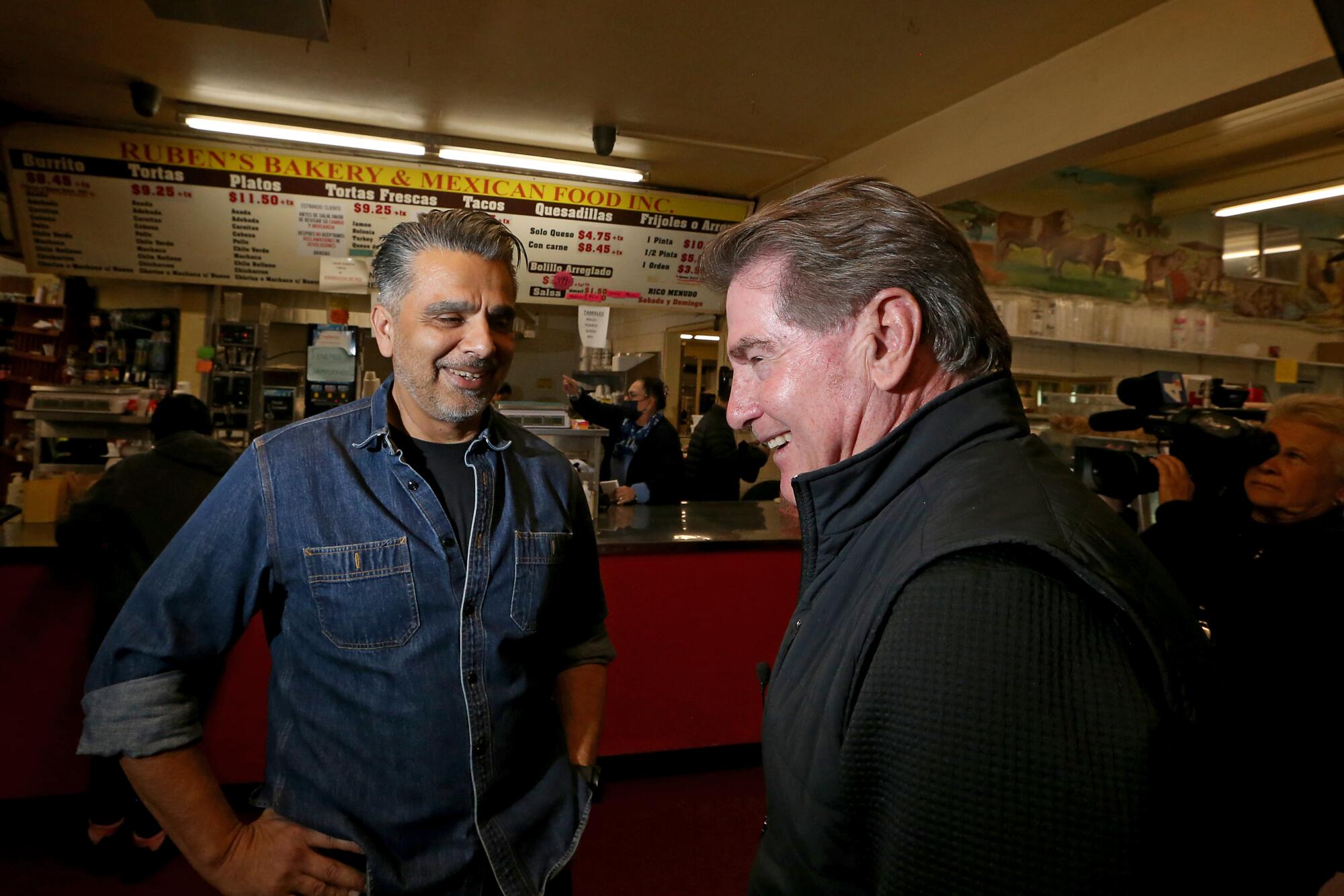 Dodgers and Padres great Steve Garvey, right, visits Ruben Ramirez Jr., who runs Ruben's Bakery and Mexican Food in Compton.