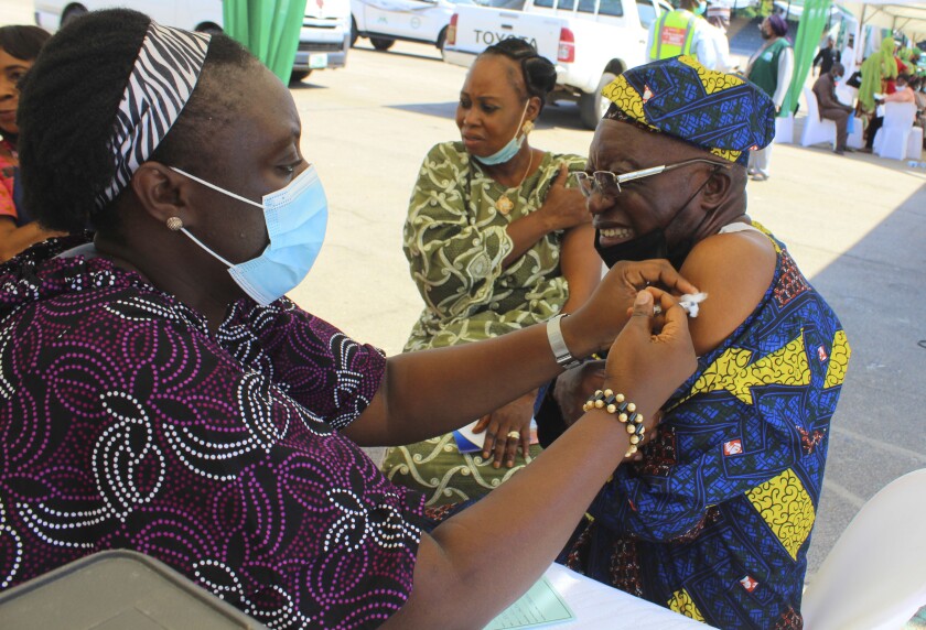 FILE- A man receives an AstraZeneca coronavirus vaccine in Abuja, Nigeria Friday, Nov 19, 2021. Nigeria has detected its first case of the omicron coronavirus variant in a sample it collected in October, weeks before South Africa alerted the world about the variant last week, the country's national public health institute said Wednesday Dec 1, 2021. (AP Photo/Gbemiga Olamikan, File)