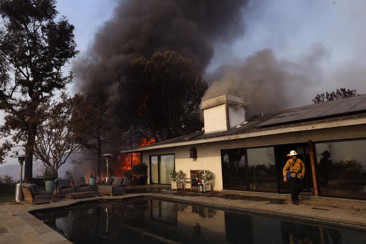 A Bel-Air home on Linda Flora Drive burns in the Skirball fire.