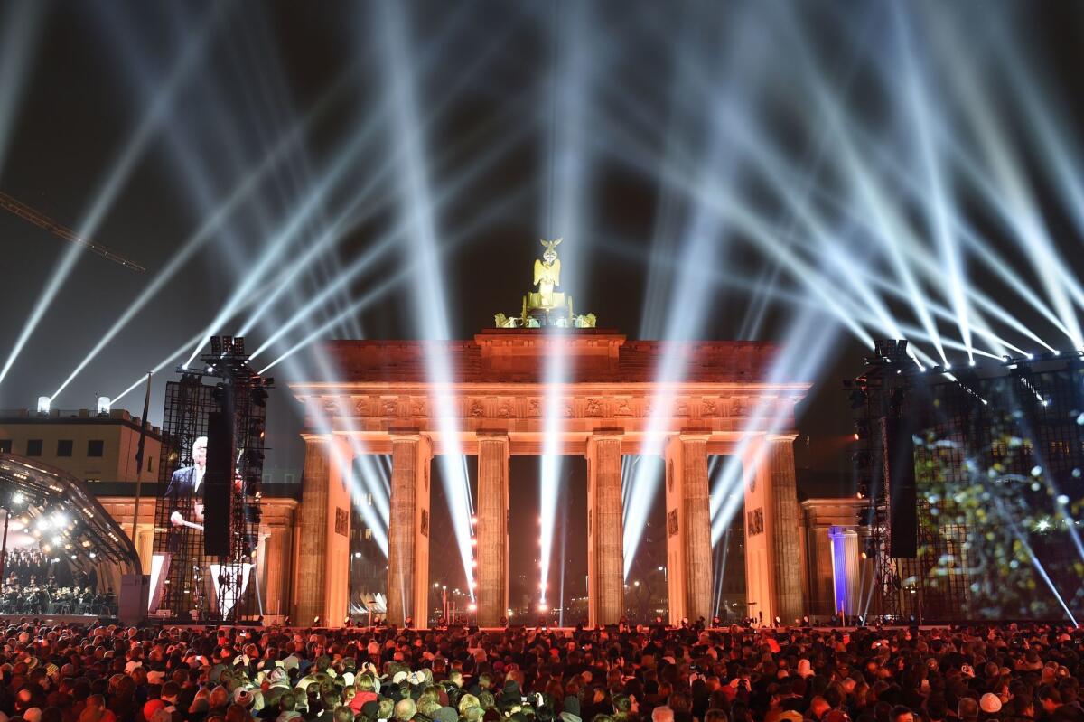 People attend a Street Party organized by German government to mark the 25th anniversary of the fall of the Berlin Wall, in front of the Brandenburg Gate on November 9, 2014 in Berlin. AFP PHOTO / ODD ANDERSENODD ANDERSEN/AFP/Getty Images ** OUTS - ELSENT, FPG - OUTS * NM, PH, VA if sourced by CT, LA or MoD **