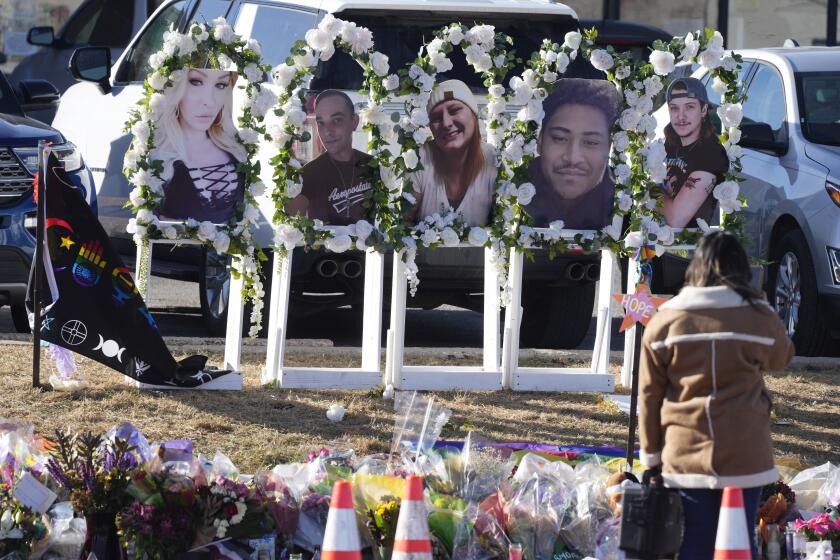 Portraits of the victims of a mass shooting at a gay nightclub are displayed at a makeshift memorial Tuesday, Nov. 22, 2022, near the scene in Colorado Springs, Colo. (AP Photo/David Zalubowski)