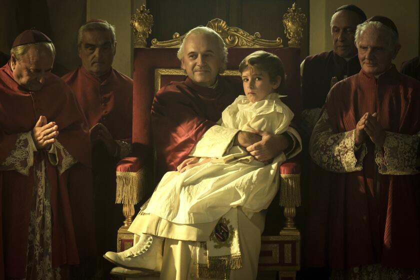 A boy sits on the lap of a pope.