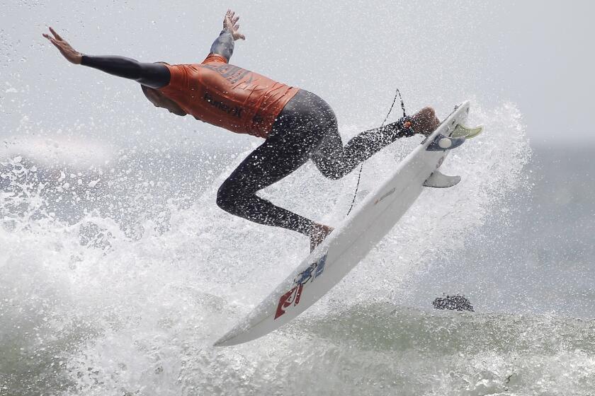 Kelly Slater launches a 360 during heat 12 the US Open of Surfing men's round of 96 on Tuesday, Aug. 2. Slater won the heat and advances in the competition. (Scott Smeltzer)