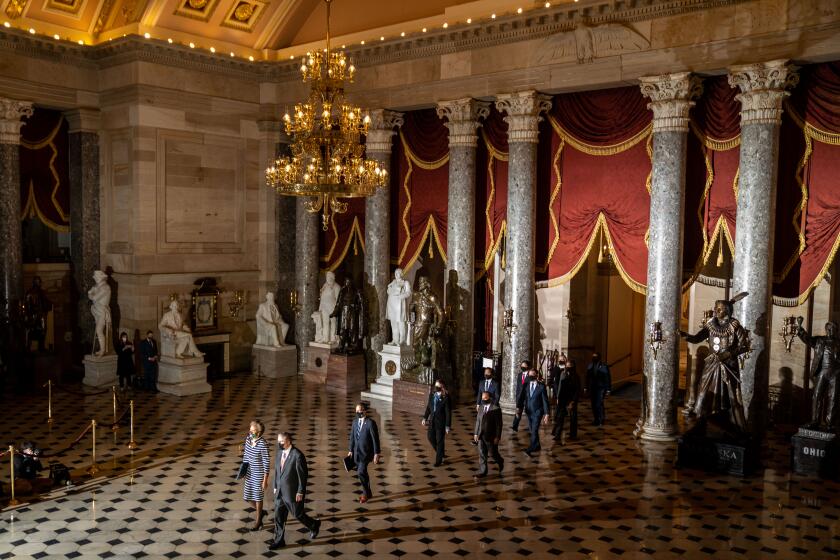WASHINGTON, DC - JANUARY 25: the articles of impeachment against former President Donald Trump are carried through National Statuary Hall on way to the United States Senate on Monday, Jan. 25, 2021 in Washington, DC. The House of Representatives voted to impeach Mr. Trump on the charge of incitement of insurrection, after a mob of the president's supporters stormed the U.S. Capitol in an attack that left five people dead.