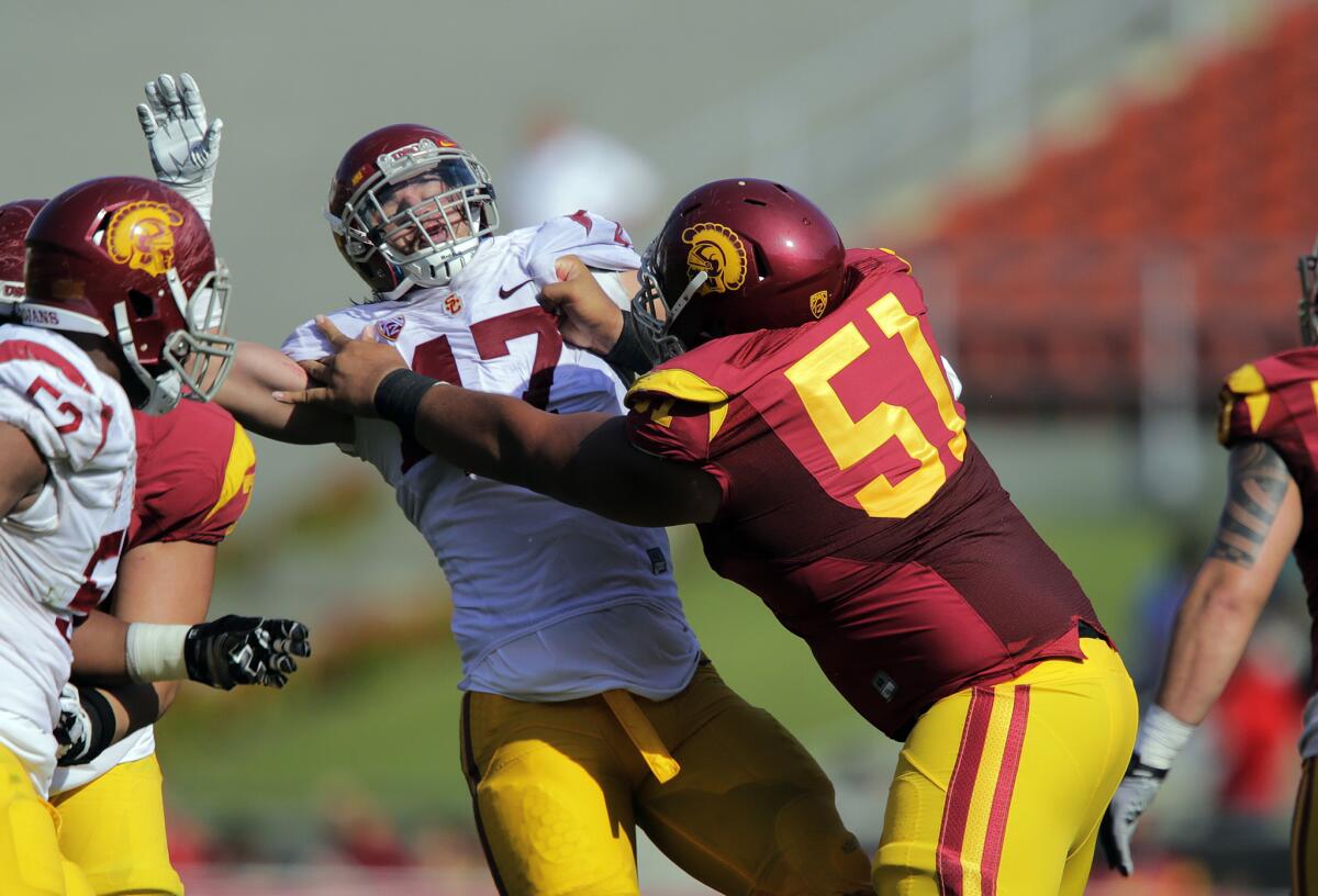 USC guard Damien Mama (51) keeps Trojans linebacker Scott Felix from getting to the quarterback during the annual spring game.