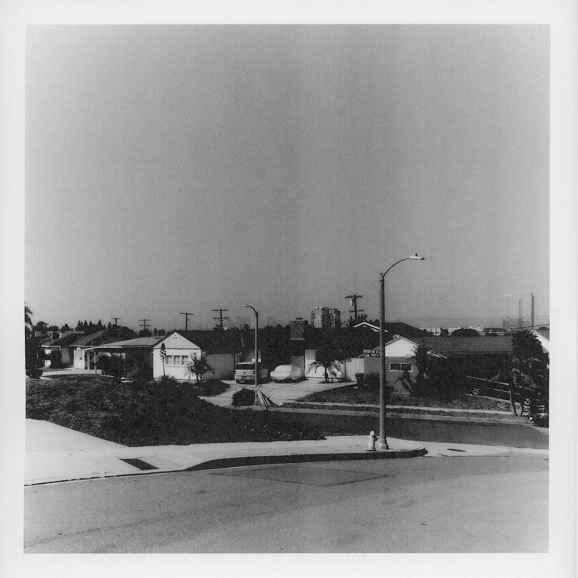 A black and white photo of streets with houses.