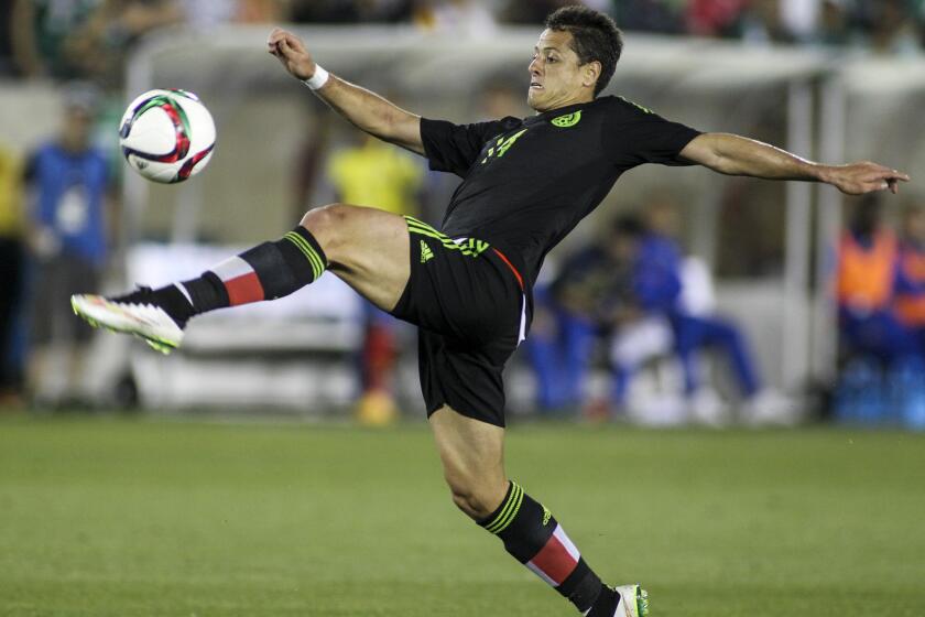 Mexico forward Javier Hernandez tries to volley a shot against Ecuador in the second half of their exhibition game on March 28 at the Coliseum.