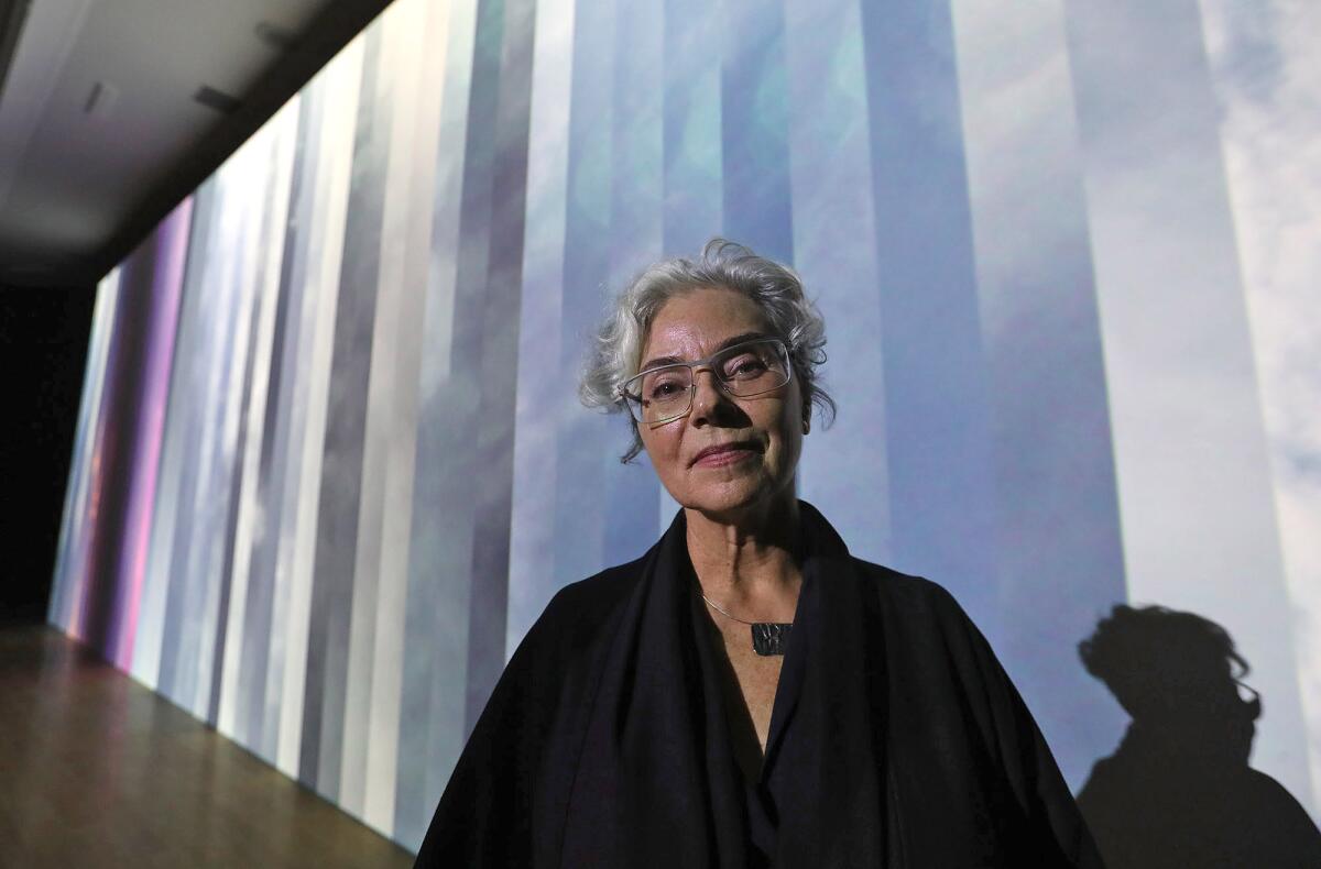 Featured artist Rebeca Mendez stands in front of her installation "Any-Instant-Whatever" at the Laguna Art Museum.