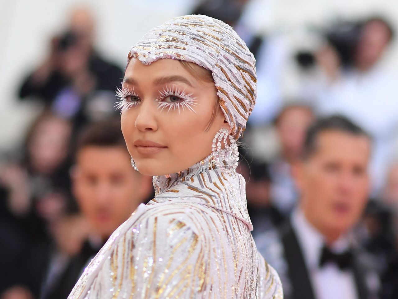Model Gigi Hadid went heavy on the sequins and silver lashes for her Met Gala look.