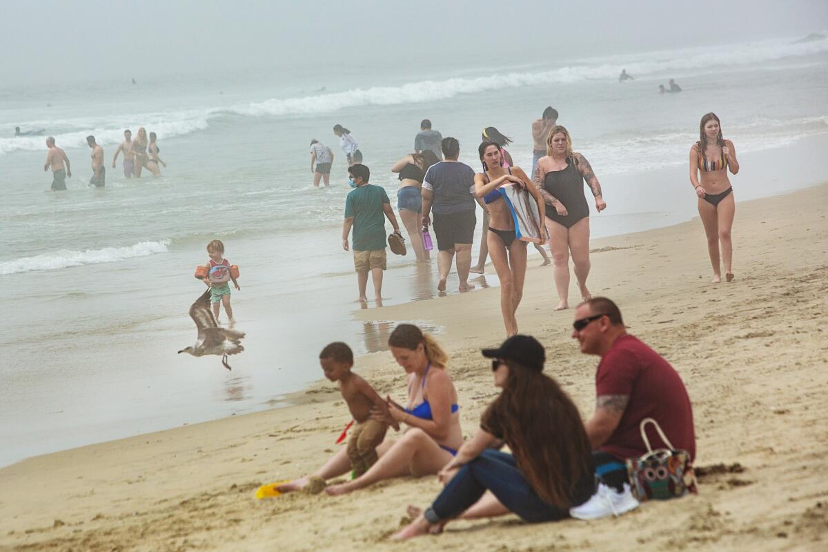 After being on lockdown for over a month because of the coronavirus pandemic, people begin to congregate at Huntington Beach on Sunday.