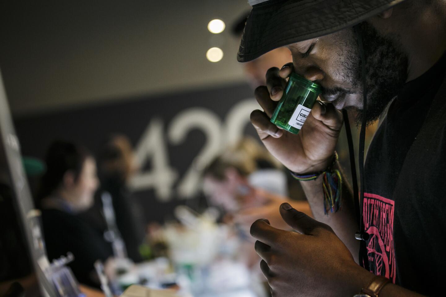 Taylor Anthony, from New York, takes a whiff of marijuana for sale at 420 Central in Santa Ana, Calif., during the first day of legal recreational-pot sales on Jan. 1.