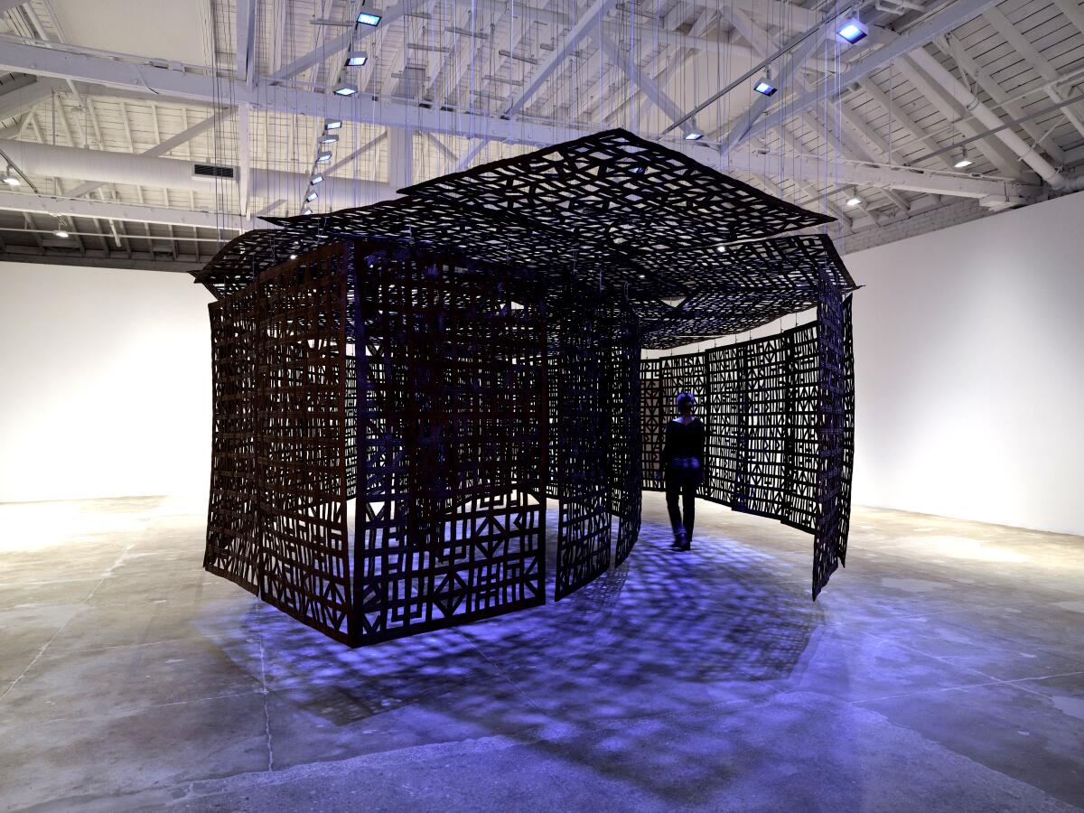 An abstract installation of a house made of steel with detailed designs.