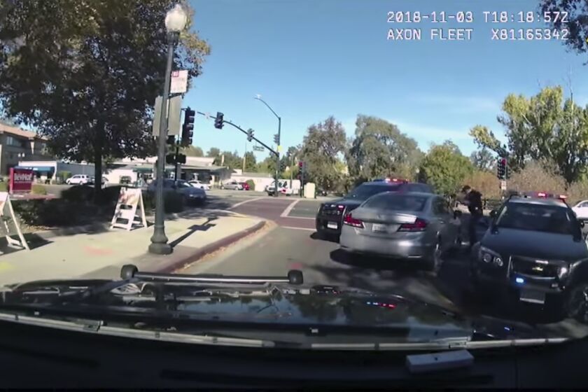 This image from body-worn camera video provided by the Contra Costa Sheriff shows Contra Costa County sheriff's Deputy Andrew Hall with his gun pointed into a car driven by Laudemar Arboleda, Nov. 3, 2018, in Danville, Calif. Hall has been charged in the fatal shooting of Arboleda, a Filipino man who was unarmed. Hall was charged with manslaughter and assault Wednesday, April 21, 2021, after shooting Arboleda nine times during the slow-moving car pursuit. (Contra Costa Sheriff via AP)