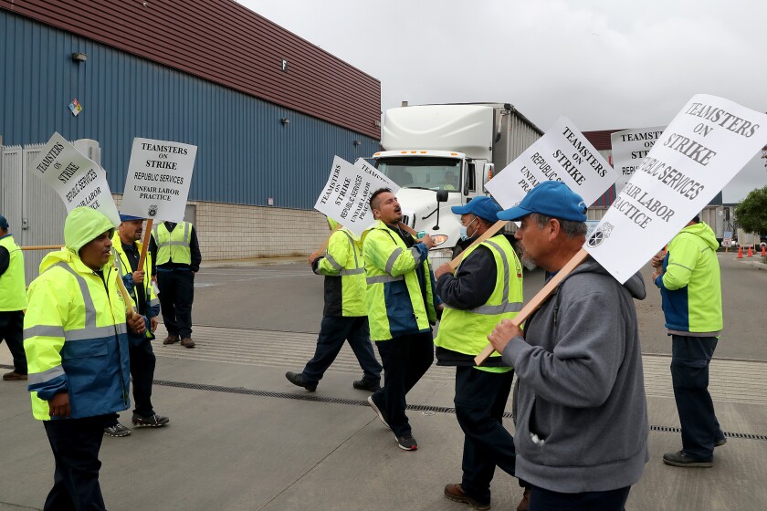 Workers demonstrate outside a Huntington Beach Republic Services facility on December 9, the first day of an eight-day strike.