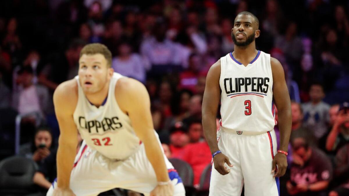 Clippers guard Chris Paul (3) and forward Blake Griffin look up during the first half of a preseason game against the Portland Trail Blazers on Oct. 13.