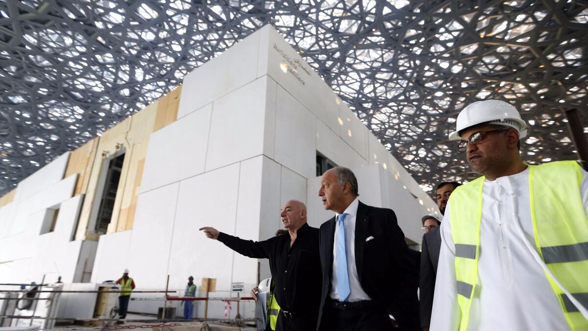 French Foreign Minister Laurent Fabius, center, and architect Jean Nouvel, left, visit the under-construction Louvre in Abu Dhabi in January.