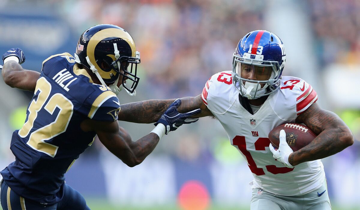 The New York Giants' Odell Beckham Jr., right, tries to shake off a tackle by the Rams' Troy Hill during the NFL International Series match Sunday in London.