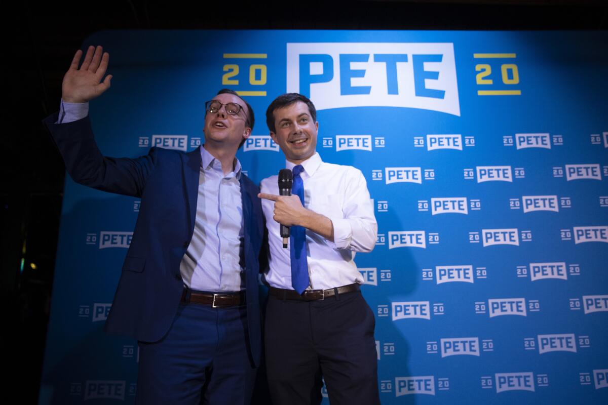 Democratic presidential candidate Pete Buttigieg, right, and husband, Chasten Glezman, acknowledge supporters at a West Hollywood campaign event in May.