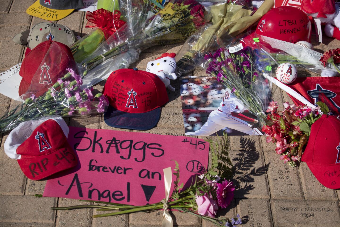 Angels fans leave items at a growing memorial for Tyler Skaggs at Angel Stadium.