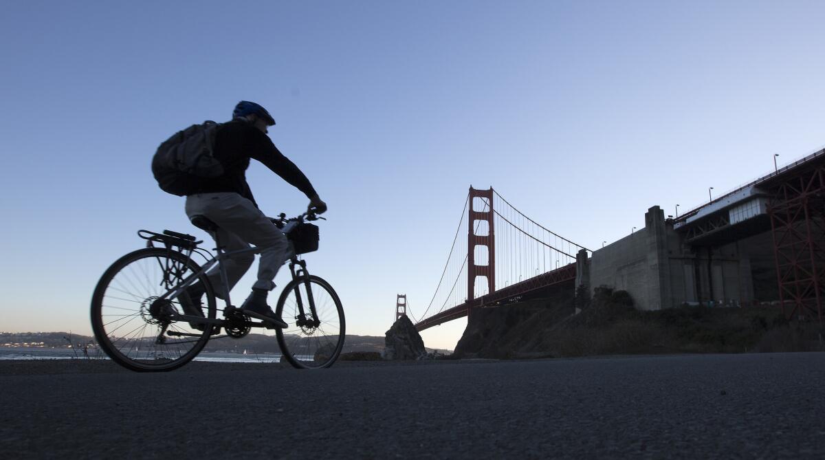 A cyclist rides along a paved road in Fort Baker in the Golden Gate National Recreation Area in San Francisco.