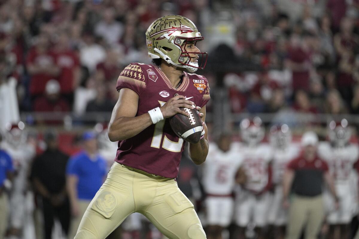 Florida State quarterback Jordan Travis looks for a wide receiver during the Cheez-It Bowl on Dec. 29.