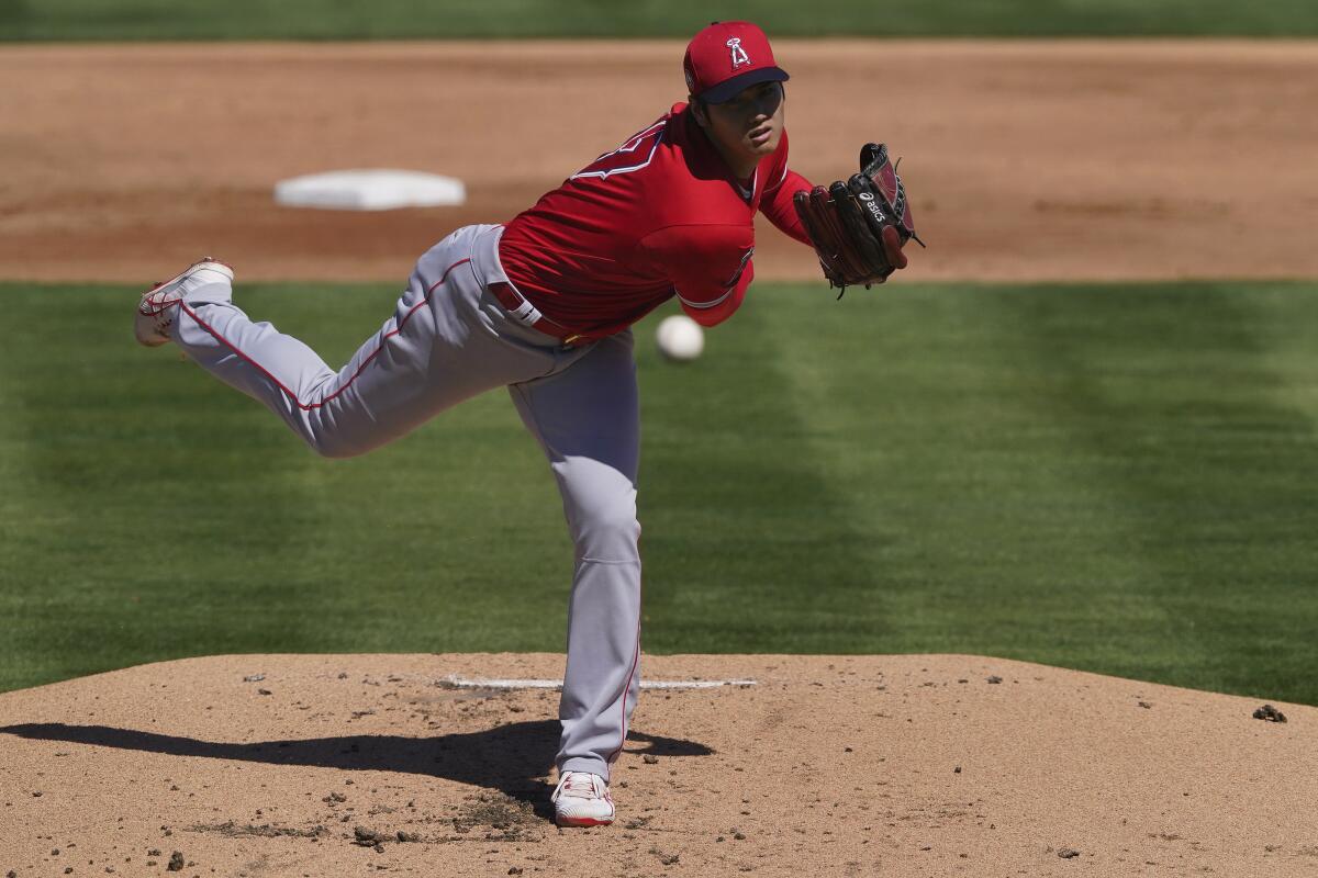 The Angels' Shohei Ohtani pitches against the Oakland Athletics in the first inning of a spring training game March 5, 2021.