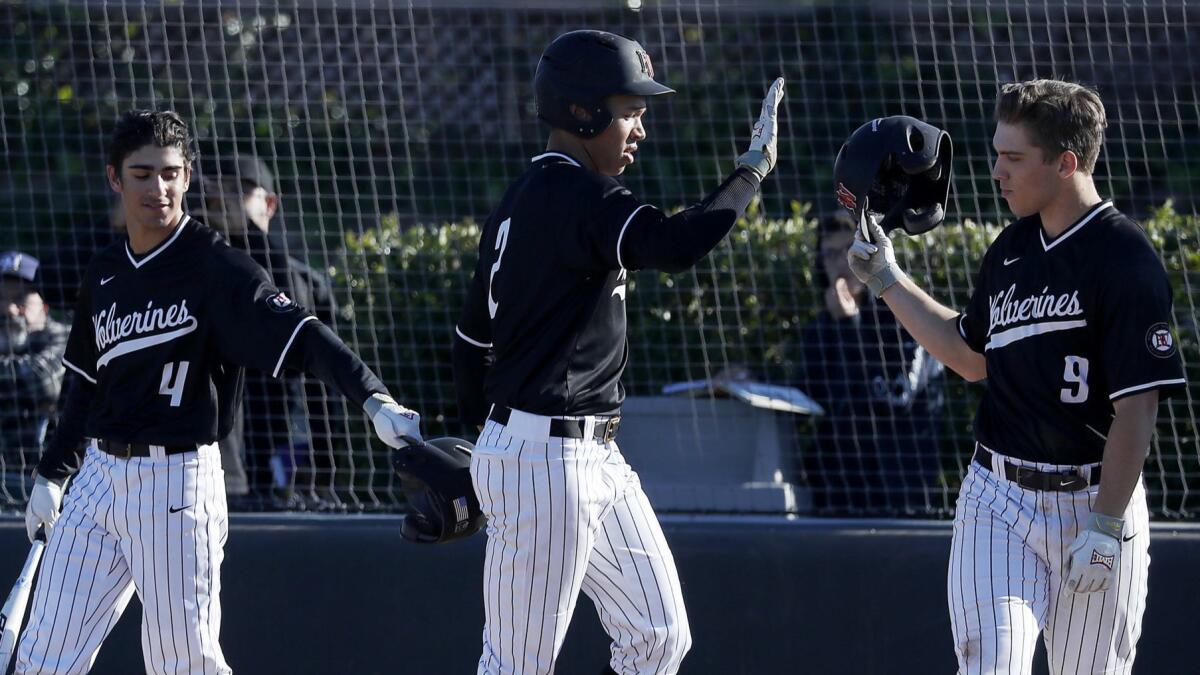 Drew Bowser, center, is congratulated by Harvard-Westlake teammates after hitting a two-run home run during a game earlier this season.