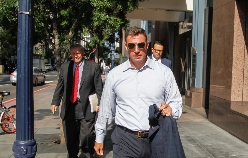 Duncan Hunter Jr., right, and one of his attorneys, Gregory Vega, walked back to their office after leaving Federal court in San Diego on Tuesday. Hunter was granted a delay in his campaign finance corruption trial which was moved from September to January.