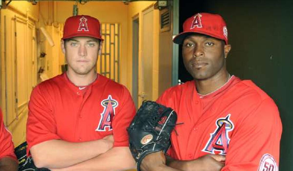 Torii Hunter, right, often took young outfielders under his wing, including Peter Bourjos , right, during his time playing with the Angels.