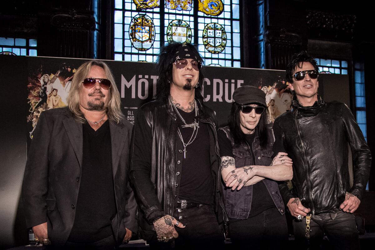 Four members of the rock band Mötley Crüe wearing all black
