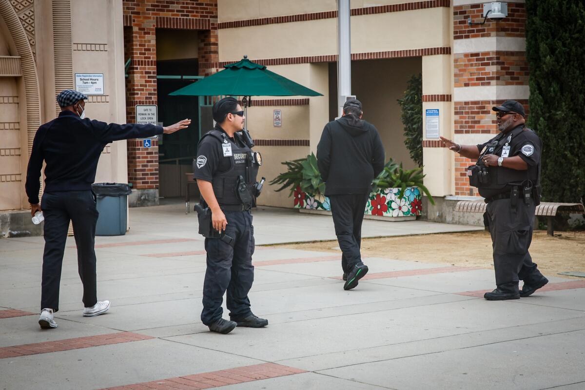 Security guards stand outside at Beverly Vista Middle School in Beverly Hills.