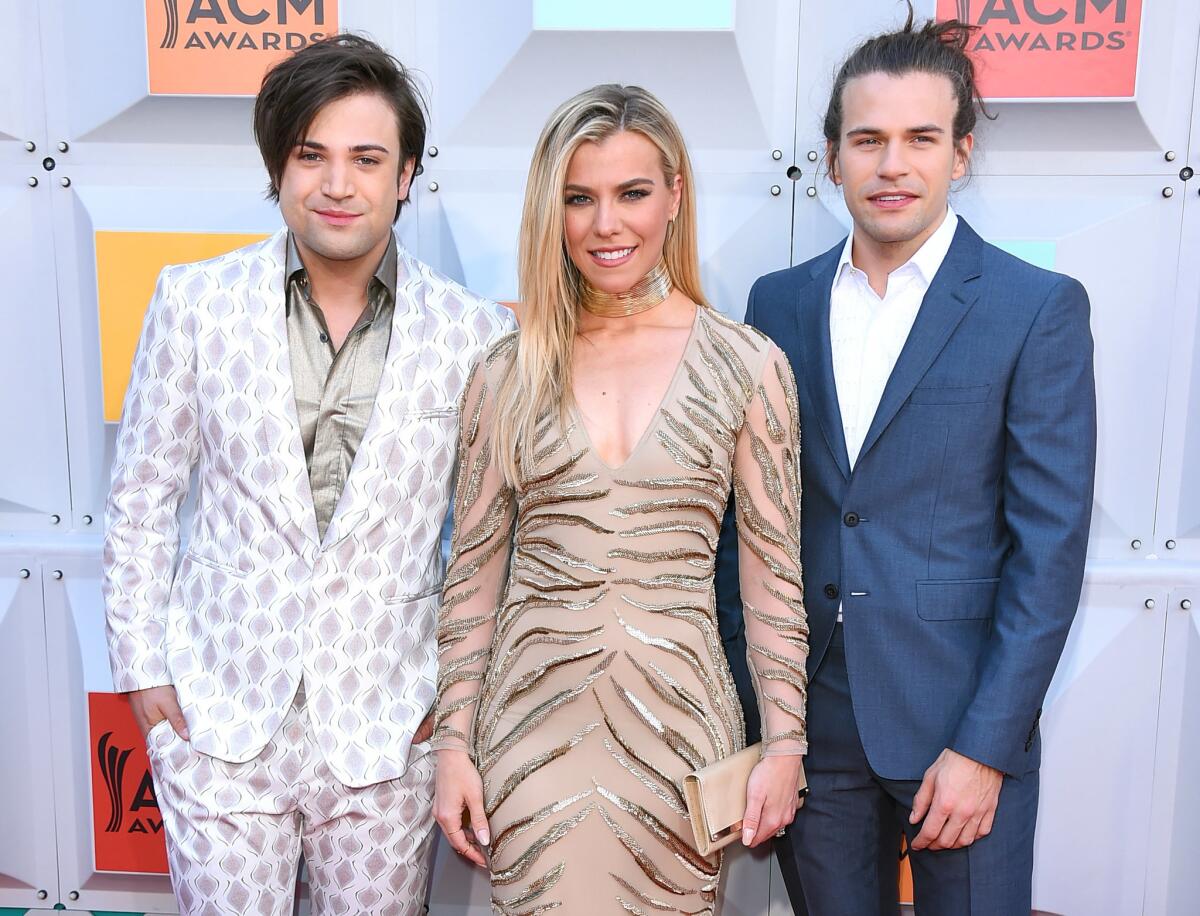 FILE - In this April 3, 2016 file photo, Neil Perry, from left, Kimberly Perry and Reid Perry, of The Band Perry, arrive at the 51st annual Academy Of Country Music Awards in Las Vegas. The band will travel to Brazil to perform at the Olympics. (Photo by Jordan Strauss/Invision/AP, File)