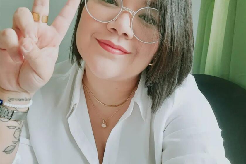 In this undated family photo, Venezuelan Edni Lopez, a political science professor and award-winning poet, flashes a vee sign at her home in Caracas, Venezuela. (Courtesy of family via AP)