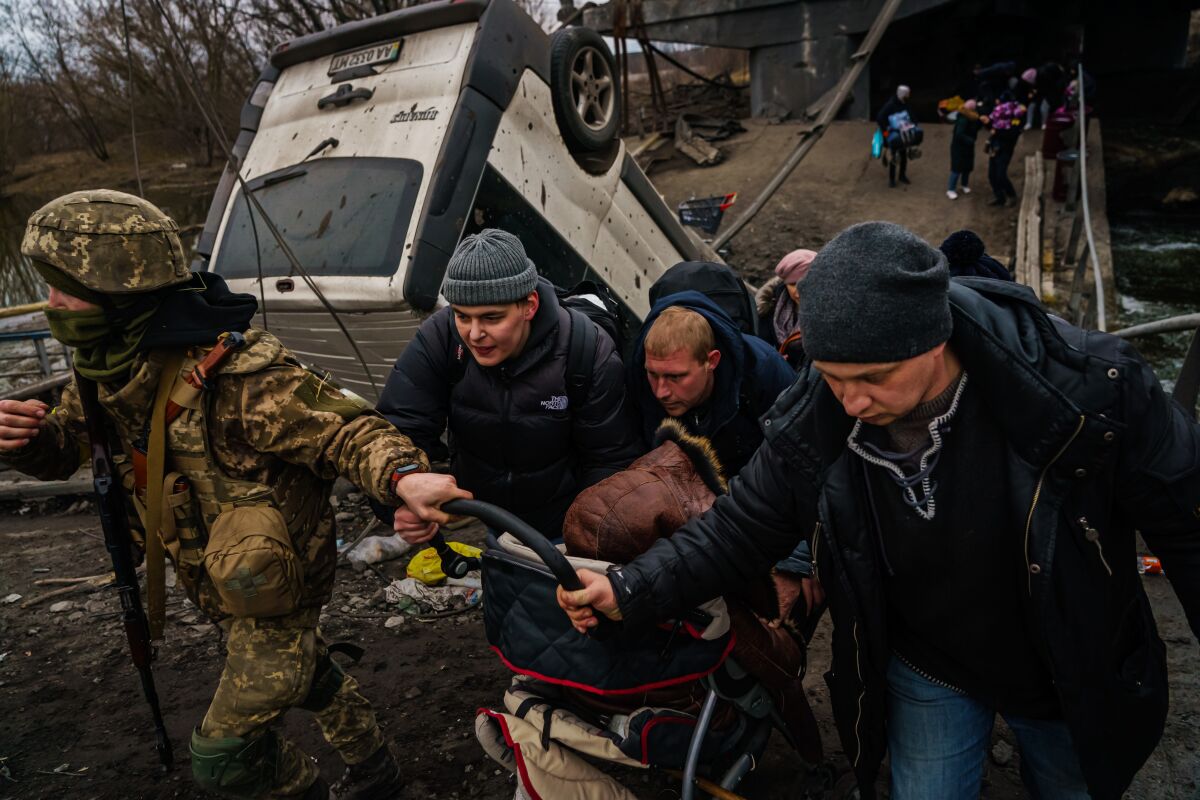 Residents of Irpin, Ukraine, evacuate as Russian forces advance and continue to bombard the town.
