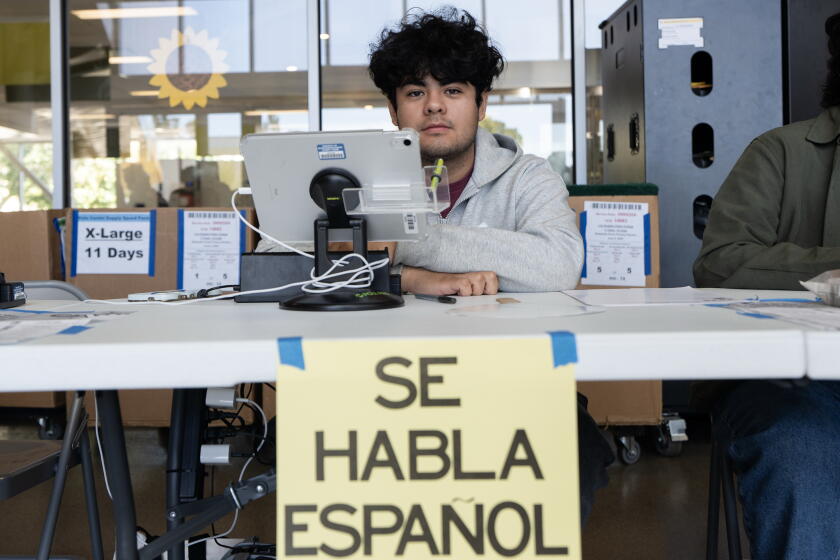 Los Angeles, California - May 30, 2026: Alan Guevara, 17, a junior at Magnolia Science Academy 2, poses for a portrait at an early voting center at Los Angeles Valley College in Valley Glen, CA on Saturday, May 30, 2026, during the Los Angeles County and California state primary elections. Guevara volunteers at the site as part of a high school volunteer program. (Karla Gachet / For The Times)