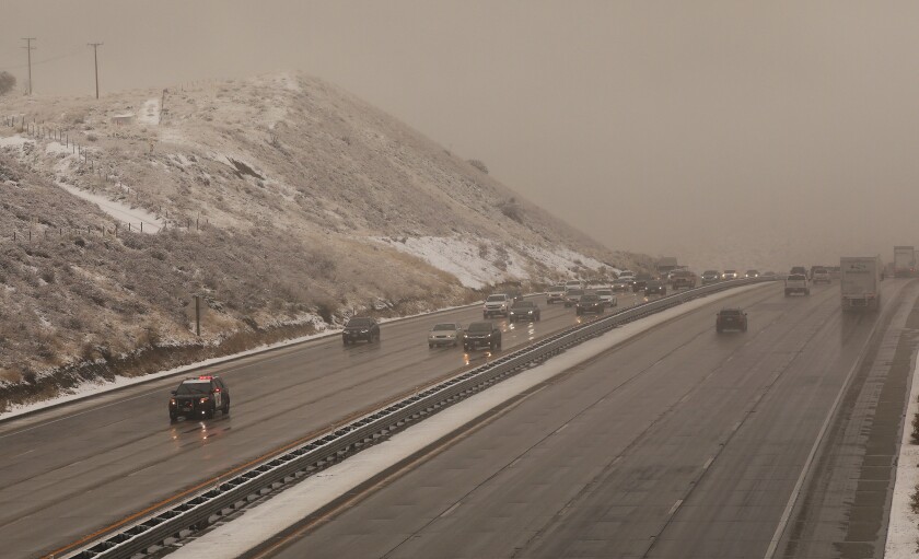 I5 closed, Cave fire fizzling out as storm swamps Southern California