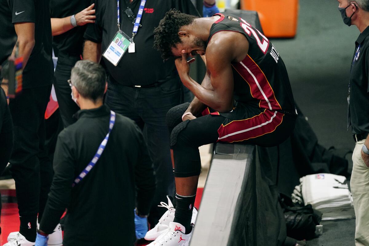 Heat Jimmy Butler composes himself after injuring his left ankle during Game 1.