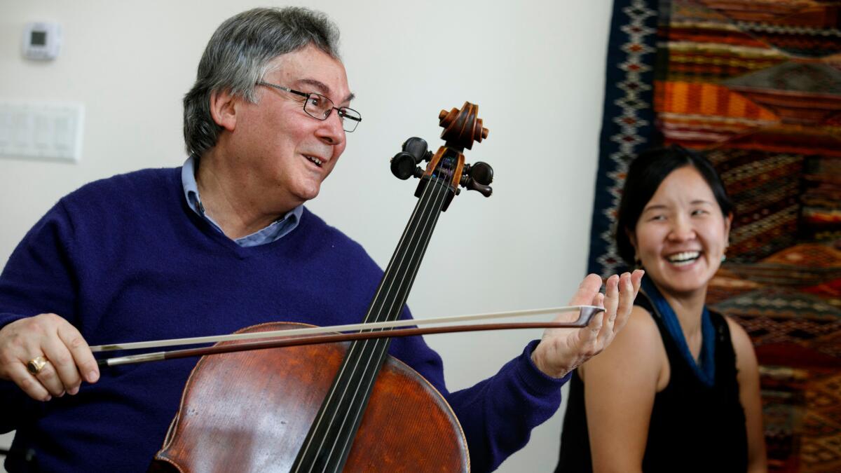 Cellist Ralph Kirshbaum, artistic director of the Piatigorsky International Cello Festival, rehearses with pianist Izumi Kashiwagi at his Los Angeles home earlier this month.