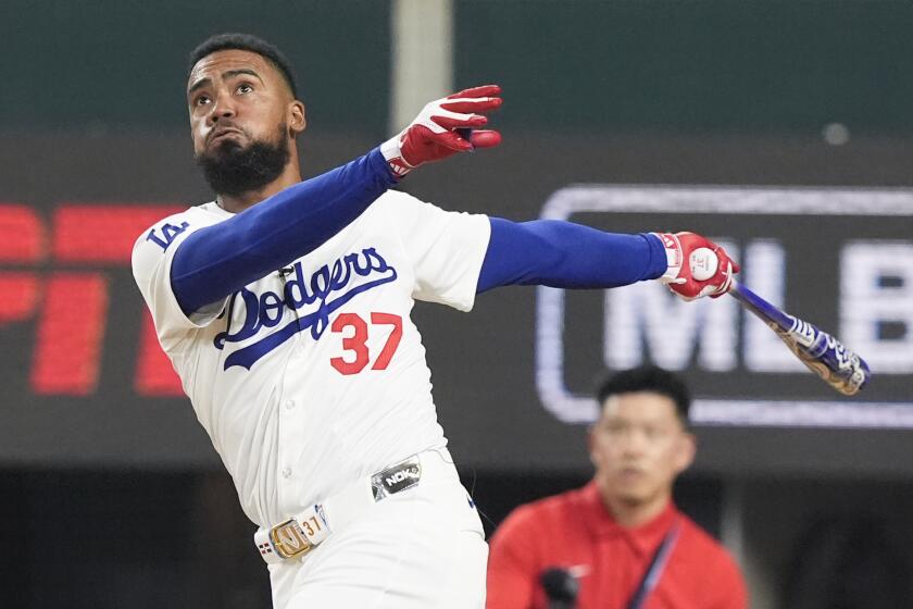 Dodgers outfielder Teoscar Hernandez follows through on a swing during the MLB Home Run Derby at Globe Life Field.