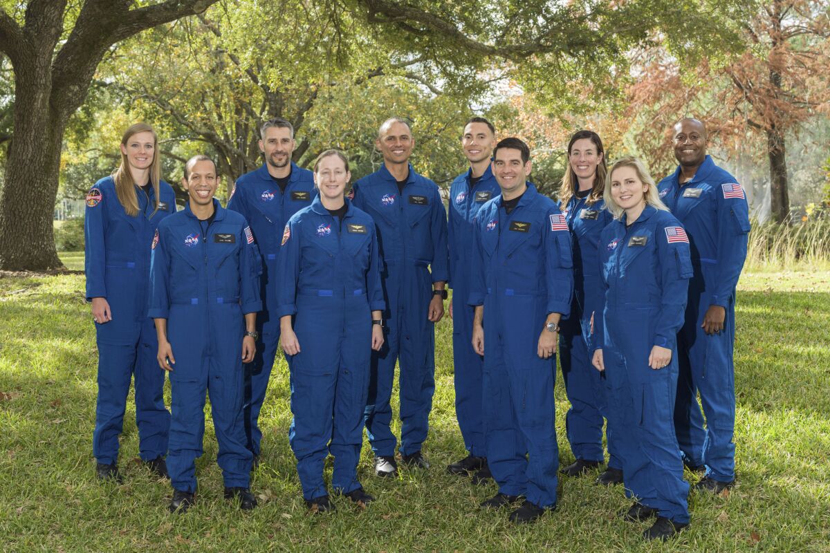 A group portrait of astronauts wearing blue jumpsuits.