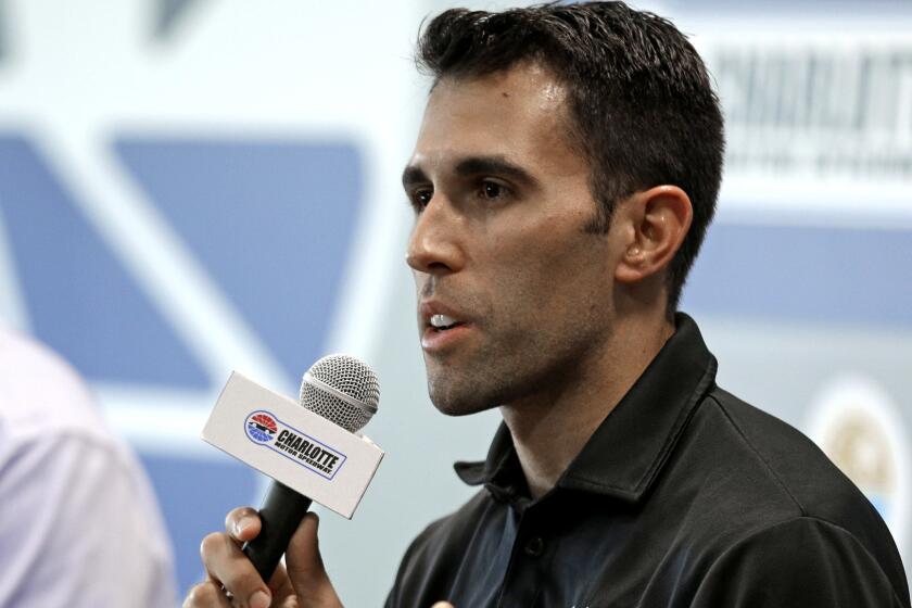 Aric Almirola speaks to the media during a news conference before practice for Saturday's NASCAR Cup series All-Star auto race at Charlotte Motor Speedway in Concord, N.C., Friday, May 19, 2017. Almirola was injured in a crash during a race last week and will be out for 8-12 weeks. (AP Photo/Chuck Burton)