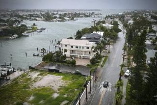 A driver negotiates a flooded street as Tropical Storm Debby passes just to the west of the Tampa Bay, Fla., region, Sunday, Aug. 4, 2024. (Max Chesnes/Tampa Bay Times via AP)