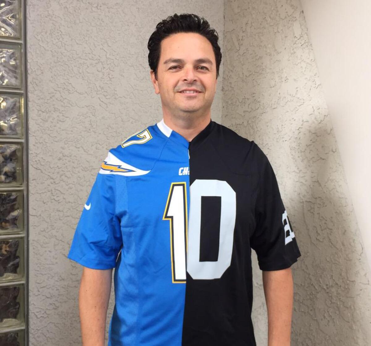 Then-Carson Councilman Albert Robles wears a split Chargers-Raiders shirt to a news conference Feb. 20, 2015.