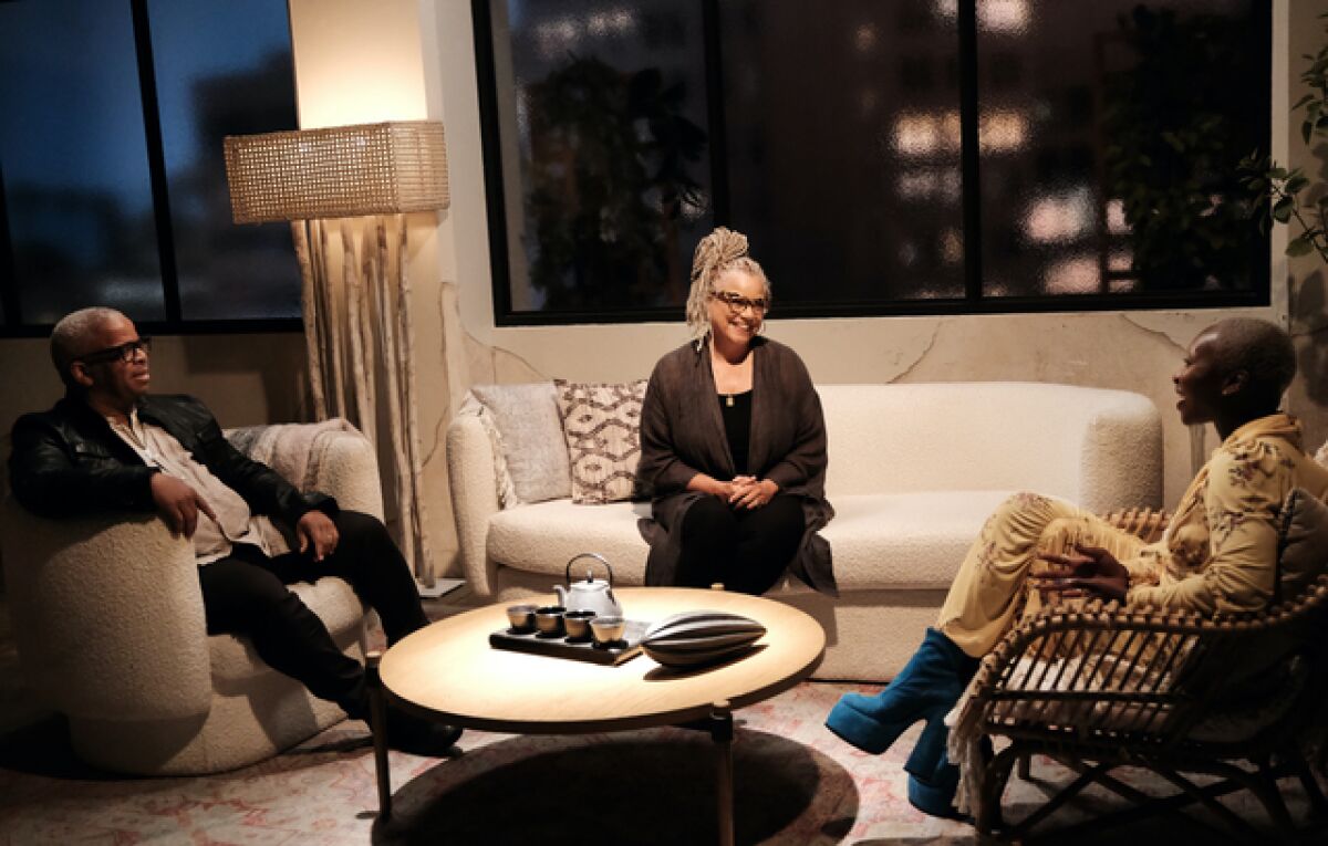 Three people sitting in a living room