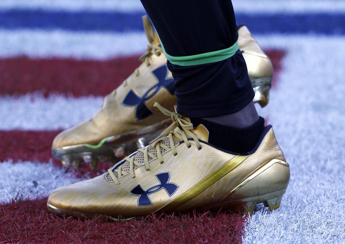 Jacksonville Jaguars' T.J. Yeldon wears Under Armour cleats for an NFL football game against the Seattle Seahawks in 2017. A strong quarter from Under Armour is overshadowed by a federal investigation into its accounting practices.
